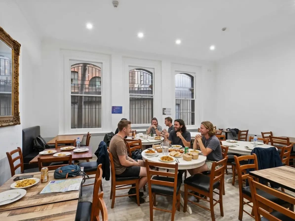 Travellers dining together in an Azzurro Sydney shared dining room
